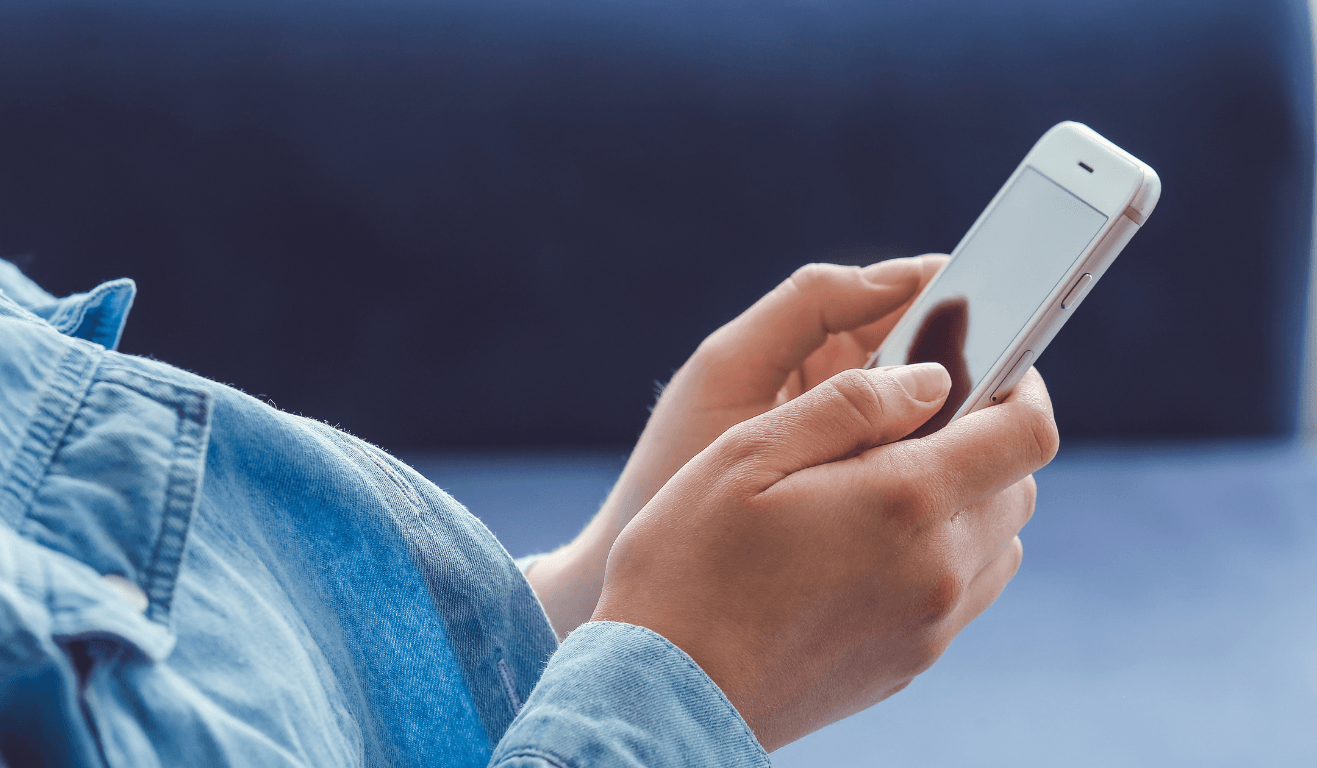 person holding a cell phone in their hand making a phone call